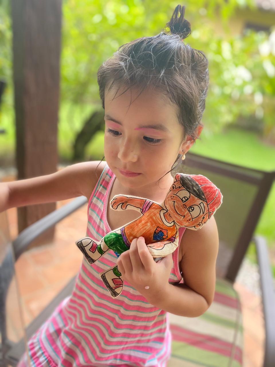 Girl playing with colored boy stuffie from Kiboo